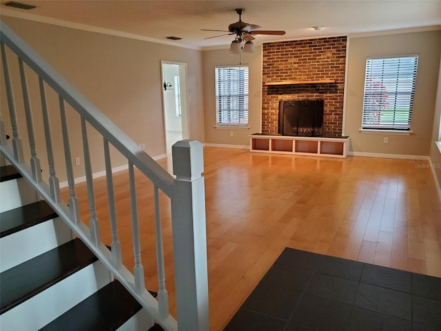 2615 Southern Oaks Pl, Plant City, FL 33566 - unfurnished living room featuring wood finished floors, ornamental molding, ceiling fan, healthy amount of natural light, and baseboards