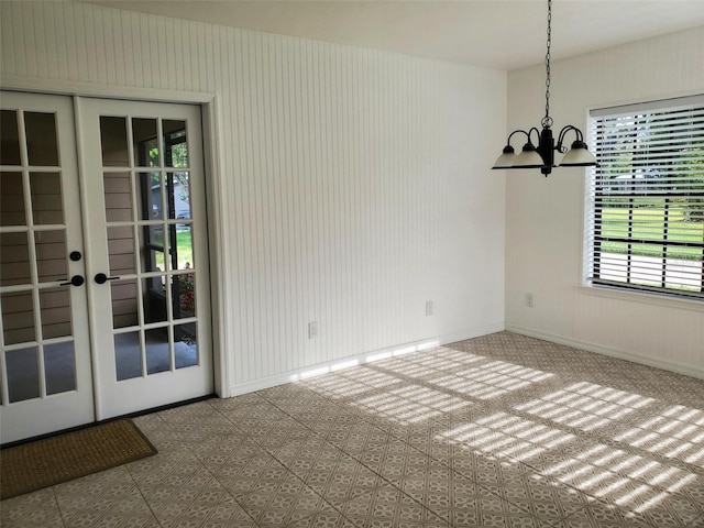 2615 Southern Oaks Pl, Plant City, FL 33566 - unfurnished dining area featuring a chandelier, baseboards, and french doors