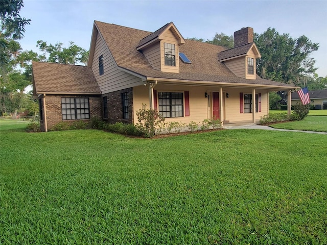 2615 Southern Oaks Pl, Plant City, FL 33566 - view of front of home with a chimney, a front lawn, a shingled roof, a porch, and brick siding