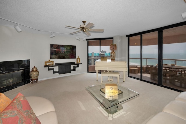 1340 Gulf Blvd Unit 16A, Clearwater Beach, FL 33767 - living area with a textured ceiling, a ceiling fan, carpet, and baseboards