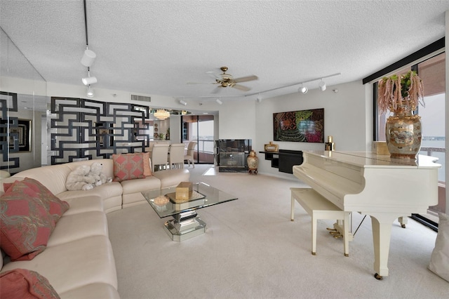 1340 Gulf Blvd Unit 16A, Clearwater Beach, FL 33767 - carpeted living room with rail lighting, a textured ceiling, and a ceiling fan