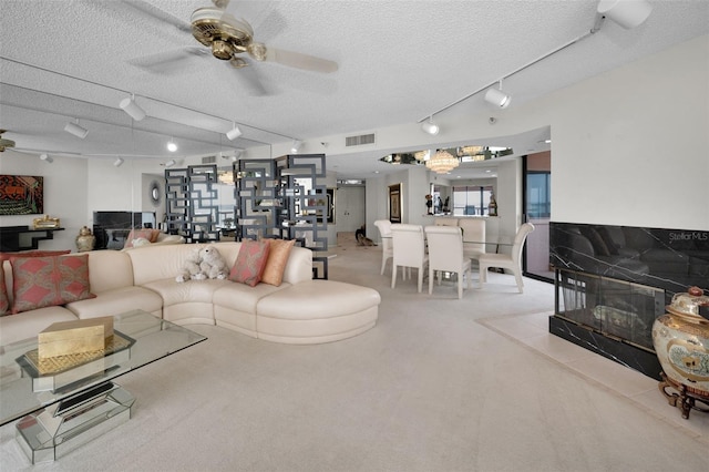1340 Gulf Blvd Unit 16A, Clearwater Beach, FL 33767 - living room with track lighting, ceiling fan, a textured ceiling, and light carpet