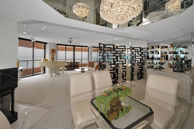 1340 Gulf Blvd Unit 16A, Clearwater Beach, FL 33767 - dining space featuring a chandelier, ceiling fan, floor to ceiling windows, and a textured ceiling