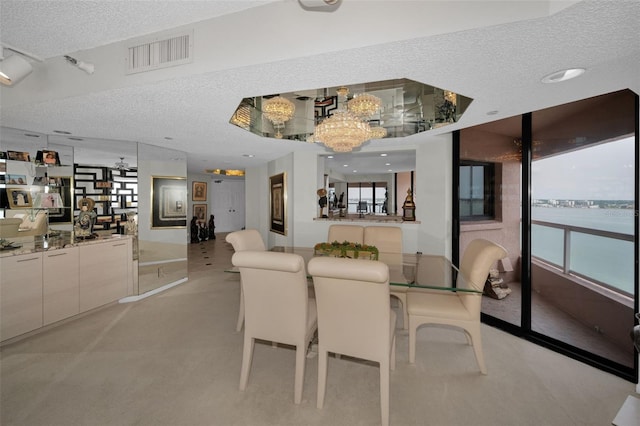 1340 Gulf Blvd Unit 16A, Clearwater Beach, FL 33767 - dining area with a textured ceiling, a chandelier, and light carpet