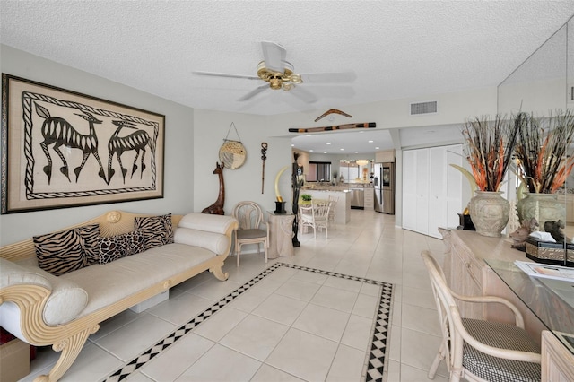 1340 Gulf Blvd Unit 16A, Clearwater Beach, FL 33767 - living room featuring light tile patterned floors, a ceiling fan, and a textured ceiling