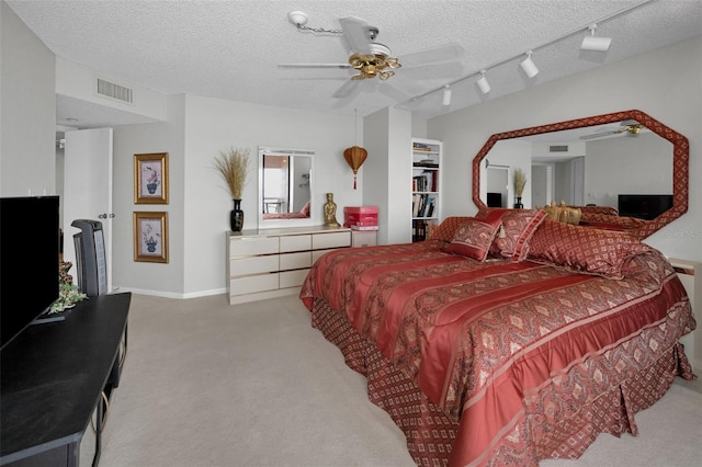 1340 Gulf Blvd Unit 16A, Clearwater Beach, FL 33767 - carpeted bedroom with track lighting, a textured ceiling, and a ceiling fan