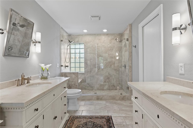 2817 Seabreeze Dr S, Gulfport, FL 33707 - bathroom featuring a shower stall, two vanities, and toilet