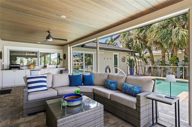 2817 Seabreeze Dr S, Gulfport, FL 33707 - view of patio featuring area for grilling, an outdoor living space, a ceiling fan, and an outdoor pool