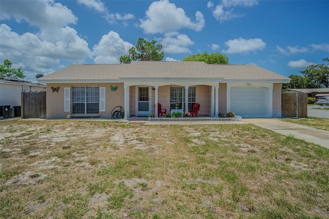 4150 Woodsville Dr, New Port Richey, FL 34652 - single story home featuring covered porch, an attached garage, stucco siding, and driveway