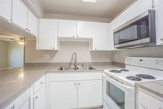 3002 W Cleveland St Unit C3, Tampa, FL 33609 - kitchen featuring electric stove, stainless steel microwave, a sink, and light countertops