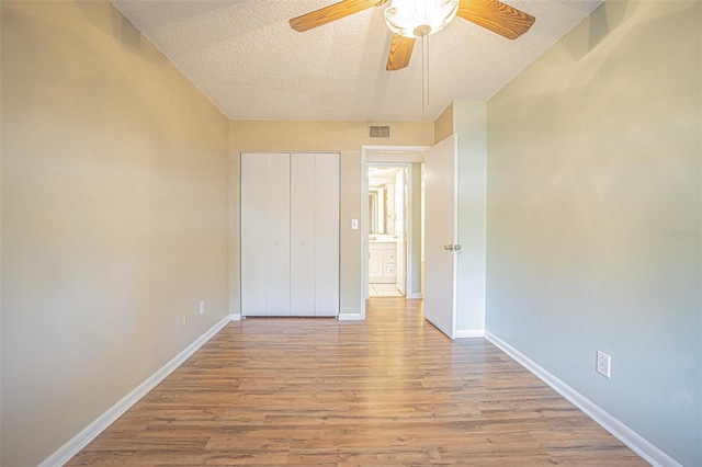 3002 W Cleveland St Unit C3, Tampa, FL 33609 - unfurnished bedroom with wood finished floors, a textured ceiling, baseboards, a closet, and ceiling fan