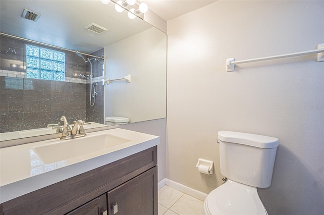 3002 W Cleveland St Unit C3, Tampa, FL 33609 - bathroom featuring toilet, tile patterned flooring, tiled shower, vanity, and baseboards
