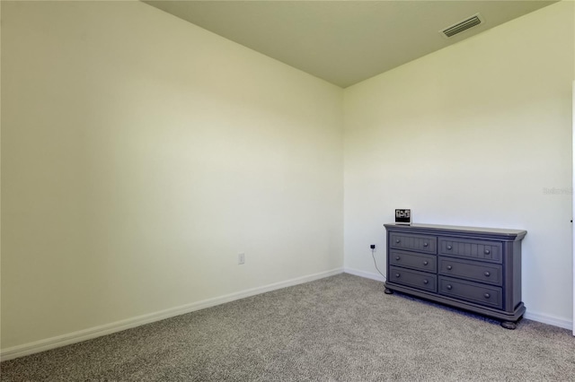 unfurnished room with light carpet and baseboards
