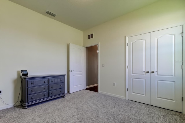 unfurnished bedroom featuring carpet floors, baseboards, and a closet