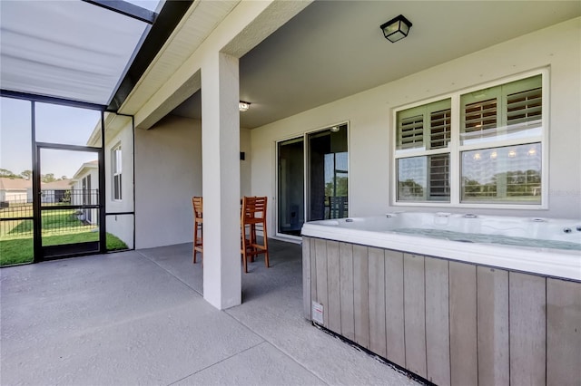 sunroom with a hot tub