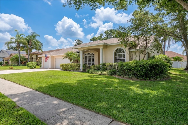 627 Belted Kingfisher Dr N, Palm Harbor, FL 34683 - view of front of property featuring stucco siding, a garage, driveway, and a front yard