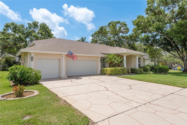 627 Belted Kingfisher Dr N, Palm Harbor, FL 34683 - view of front facade featuring stucco siding, a garage, a front yard, concrete driveway, and a shingled roof