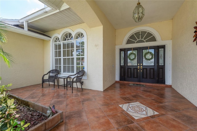 627 Belted Kingfisher Dr N, Palm Harbor, FL 34683 - entrance to property featuring french doors and stucco siding
