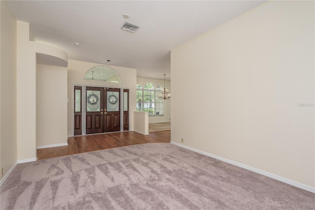 627 Belted Kingfisher Dr N, Palm Harbor, FL 34683 - entryway featuring carpet flooring, a chandelier, and baseboards