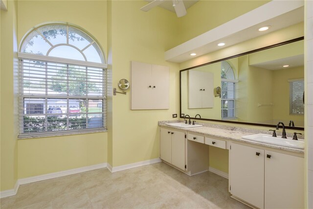 627 Belted Kingfisher Dr N, Palm Harbor, FL 34683 - bathroom featuring plenty of natural light, double vanity, a ceiling fan, baseboards, and recessed lighting