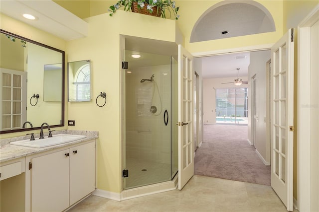 627 Belted Kingfisher Dr N, Palm Harbor, FL 34683 - full bathroom with french doors, a shower stall, vanity, baseboards, and ceiling fan