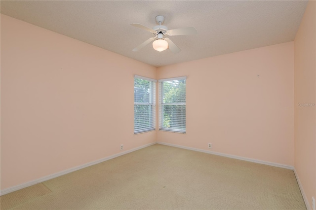 627 Belted Kingfisher Dr N, Palm Harbor, FL 34683 - empty room featuring light colored carpet, baseboards, and a ceiling fan