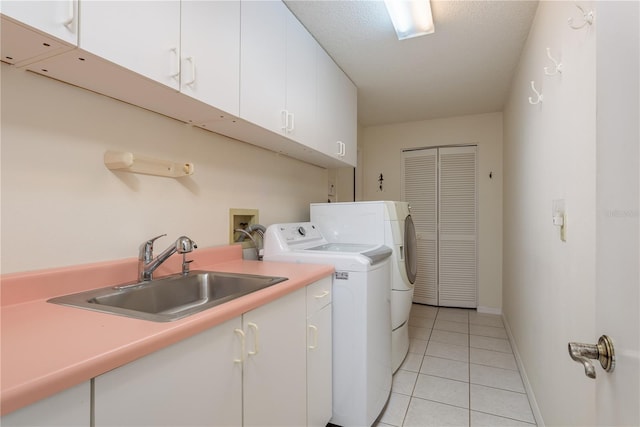 627 Belted Kingfisher Dr N, Palm Harbor, FL 34683 - laundry area featuring independent washer and dryer, cabinet space, light tile patterned floors, and baseboards
