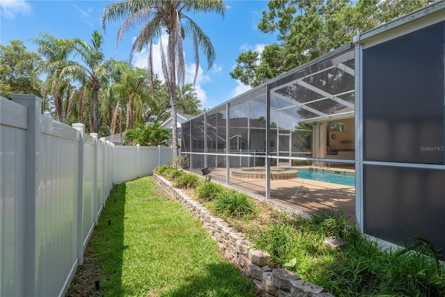 627 Belted Kingfisher Dr N, Palm Harbor, FL 34683 - fenced backyard with a pool with connected hot tub, glass enclosure, and a patio