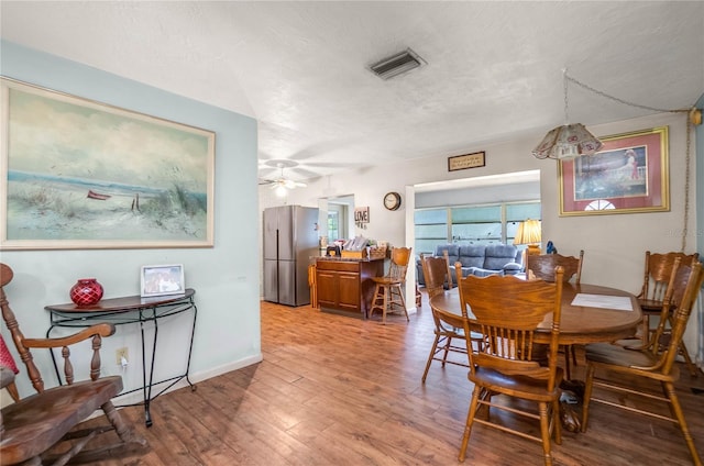 28 N Edinburgh Dr, Inverness, FL 34450 - dining room with wood finished floors, baseboards, a ceiling fan, and a textured ceiling