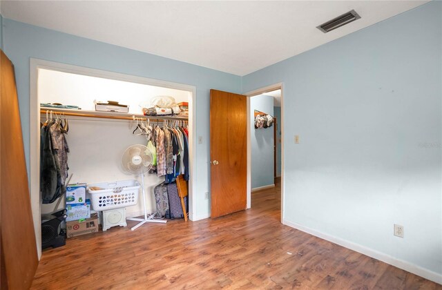 28 N Edinburgh Dr, Inverness, FL 34450 - bedroom featuring a closet, wood finished floors, and baseboards