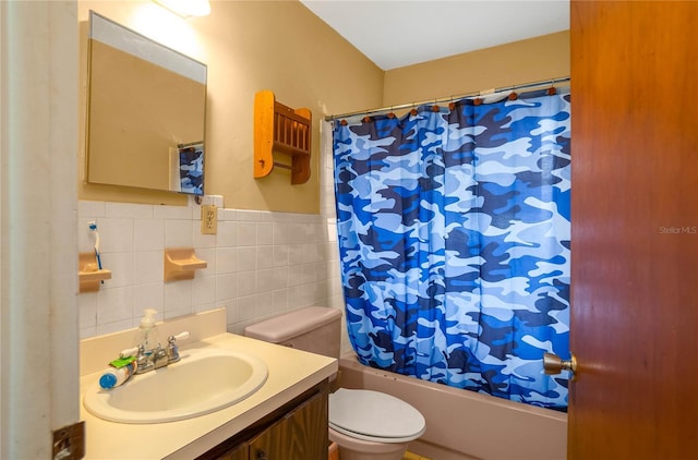 28 N Edinburgh Dr, Inverness, FL 34450 - bathroom with tile walls, toilet, shower / bath combo with shower curtain, vanity, and a wainscoted wall