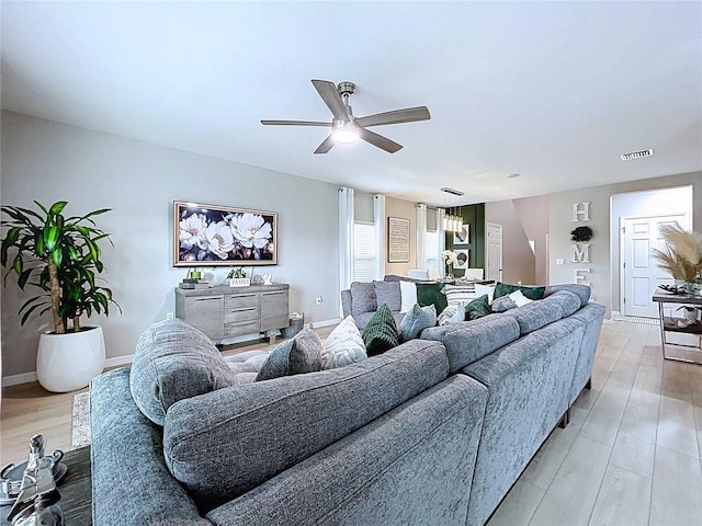 34056 Scarlet Sage Ct, Wesley Chapel, FL 33545 - living room with ceiling fan, light wood-style flooring, and baseboards