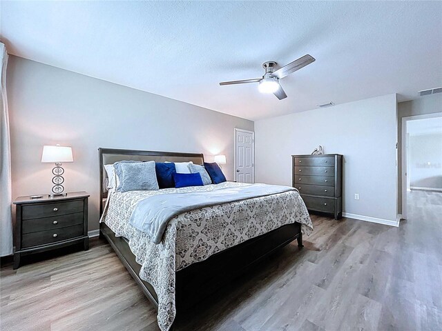 34056 Scarlet Sage Ct, Wesley Chapel, FL 33545 - bedroom featuring wood finished floors, a ceiling fan, baseboards, and a textured ceiling