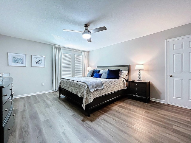 34056 Scarlet Sage Ct, Wesley Chapel, FL 33545 - bedroom with wood finished floors, baseboards, a ceiling fan, and a textured ceiling