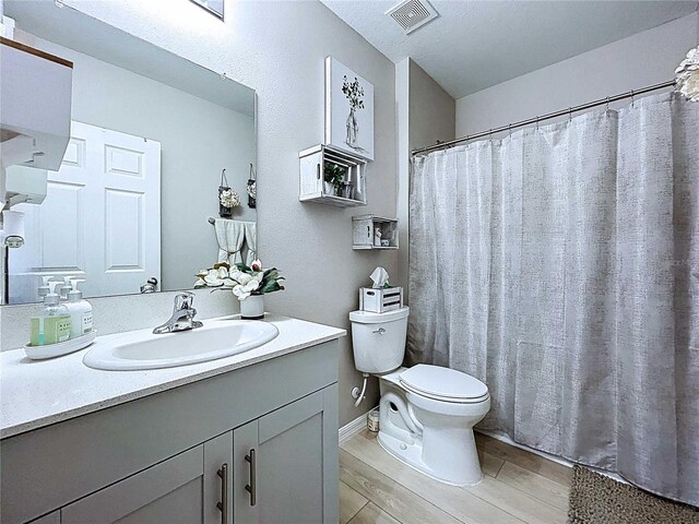34056 Scarlet Sage Ct, Wesley Chapel, FL 33545 - full bath with toilet, vanity, and wood finished floors