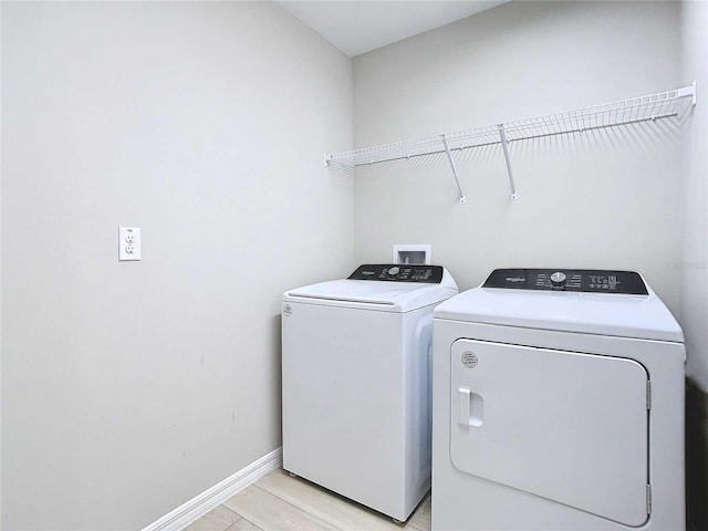 34056 Scarlet Sage Ct, Wesley Chapel, FL 33545 - laundry room featuring washing machine and clothes dryer and baseboards