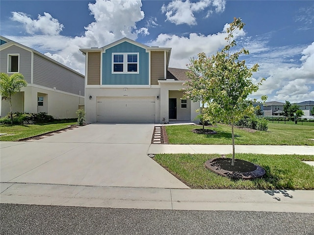 34056 Scarlet Sage Ct, Wesley Chapel, FL 33545 - view of front facade with an attached garage, driveway, board and batten siding, and a front lawn