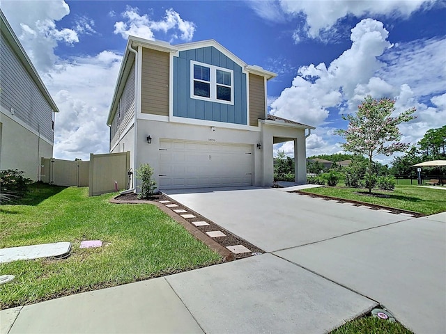 34056 Scarlet Sage Ct, Wesley Chapel, FL 33545 - view of front of property featuring a garage, board and batten siding, concrete driveway, and stucco siding