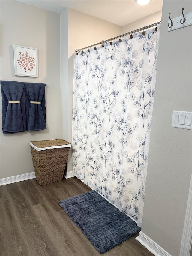 34056 Scarlet Sage Ct, Wesley Chapel, FL 33545 - bathroom featuring wood finished floors, baseboards, and curtained shower