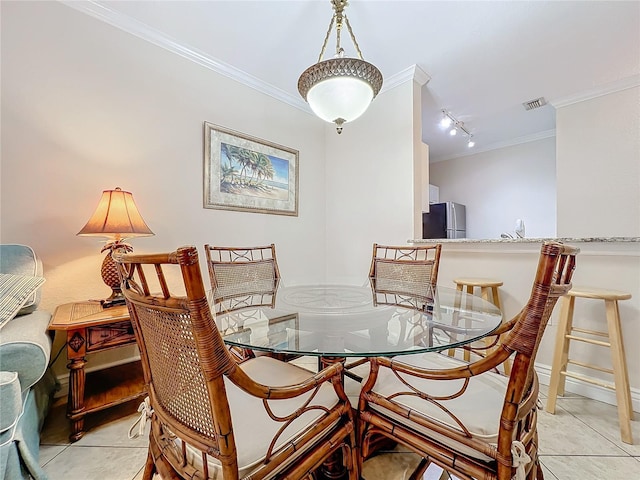 2724 Via Murano Unit 615, Clearwater, FL 33764 - dining space featuring ornamental molding, light tile patterned floors, rail lighting, and baseboards