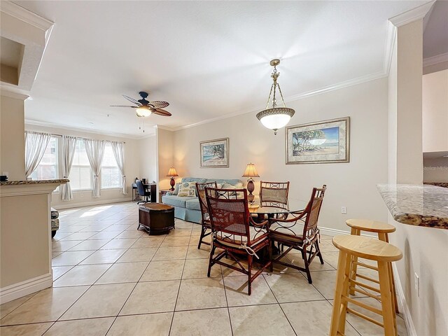 2724 Via Murano Unit 615, Clearwater, FL 33764 - dining space with crown molding, a ceiling fan, light tile patterned flooring, and baseboards