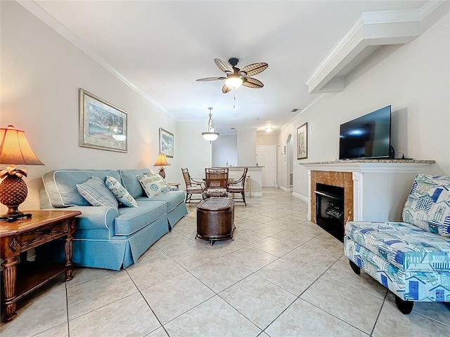 2724 Via Murano Unit 615, Clearwater, FL 33764 - living area with ceiling fan, crown molding, light tile patterned flooring, a fireplace, and baseboards