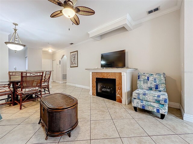 2724 Via Murano Unit 615, Clearwater, FL 33764 - living room with crown molding, a ceiling fan, arched walkways, light tile patterned floors, and baseboards