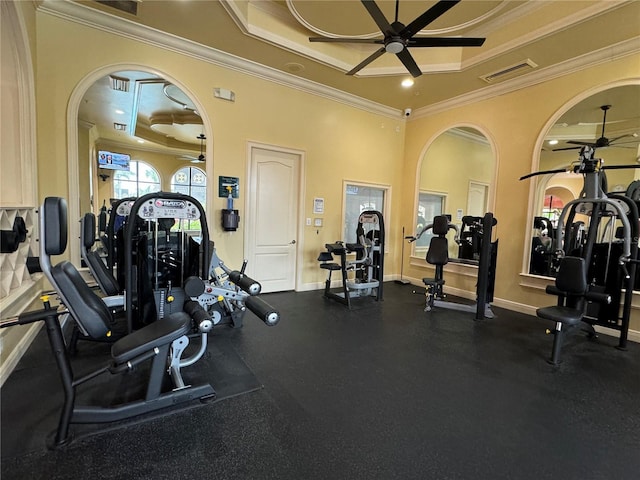 2724 Via Murano Unit 615, Clearwater, FL 33764 - workout area with a ceiling fan, ornamental molding, arched walkways, a raised ceiling, and baseboards