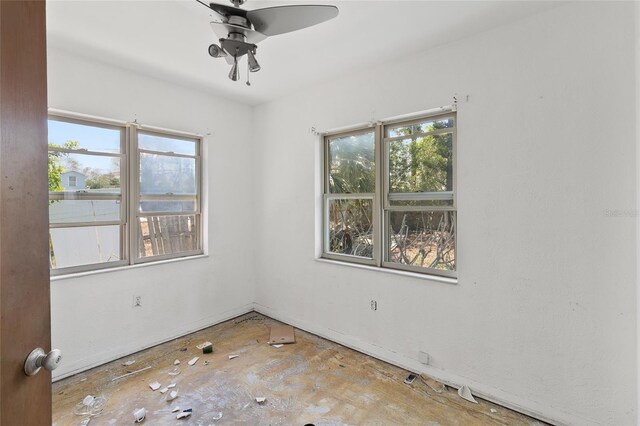 410 73rd Ave, St Pete Beach, FL 33706 - spare room featuring plenty of natural light, a ceiling fan, and baseboards