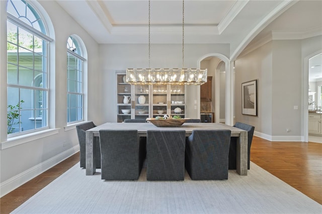 4512 Cheval Blvd, Lutz, FL 33558 - dining area with arched walkways, wood finished floors, and a tray ceiling