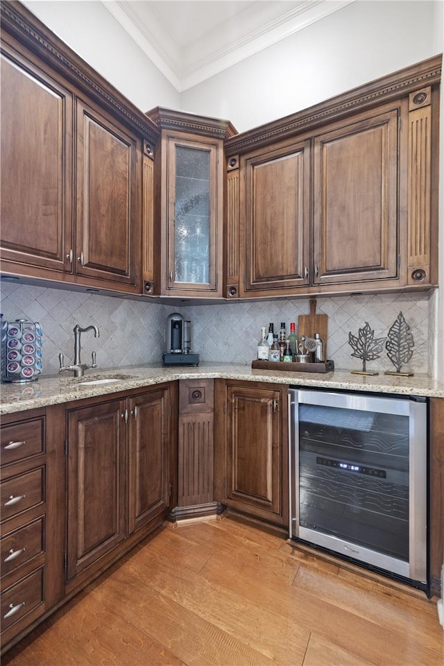 4512 Cheval Blvd, Lutz, FL 33558 - indoor dry bar with wine cooler, light wood-type flooring, crown molding, and decorative backsplash