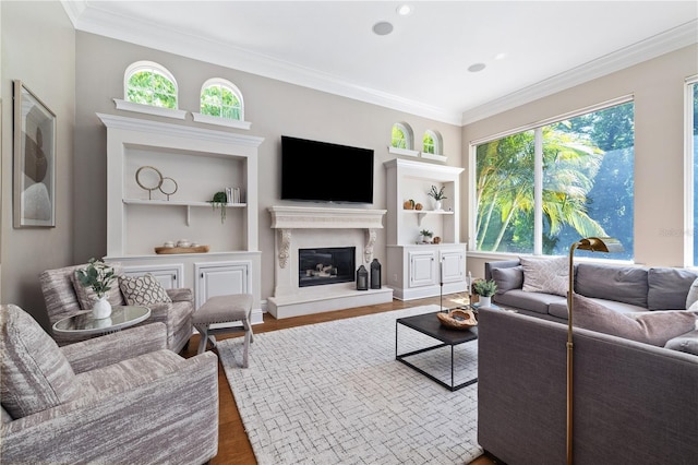 4512 Cheval Blvd, Lutz, FL 33558 - living room featuring ornamental molding, built in shelves, healthy amount of natural light, wood finished floors, and a high end fireplace