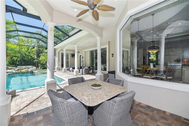 4512 Cheval Blvd, Lutz, FL 33558 - view of patio with ceiling fan, glass enclosure, a pool with connected hot tub, outdoor dining area, and an outdoor hangout area