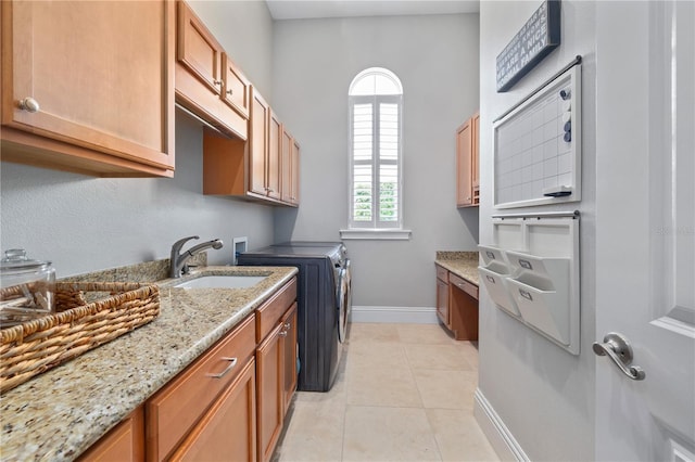 4512 Cheval Blvd, Lutz, FL 33558 - clothes washing area with washing machine and clothes dryer, cabinet space, baseboards, and light tile patterned flooring